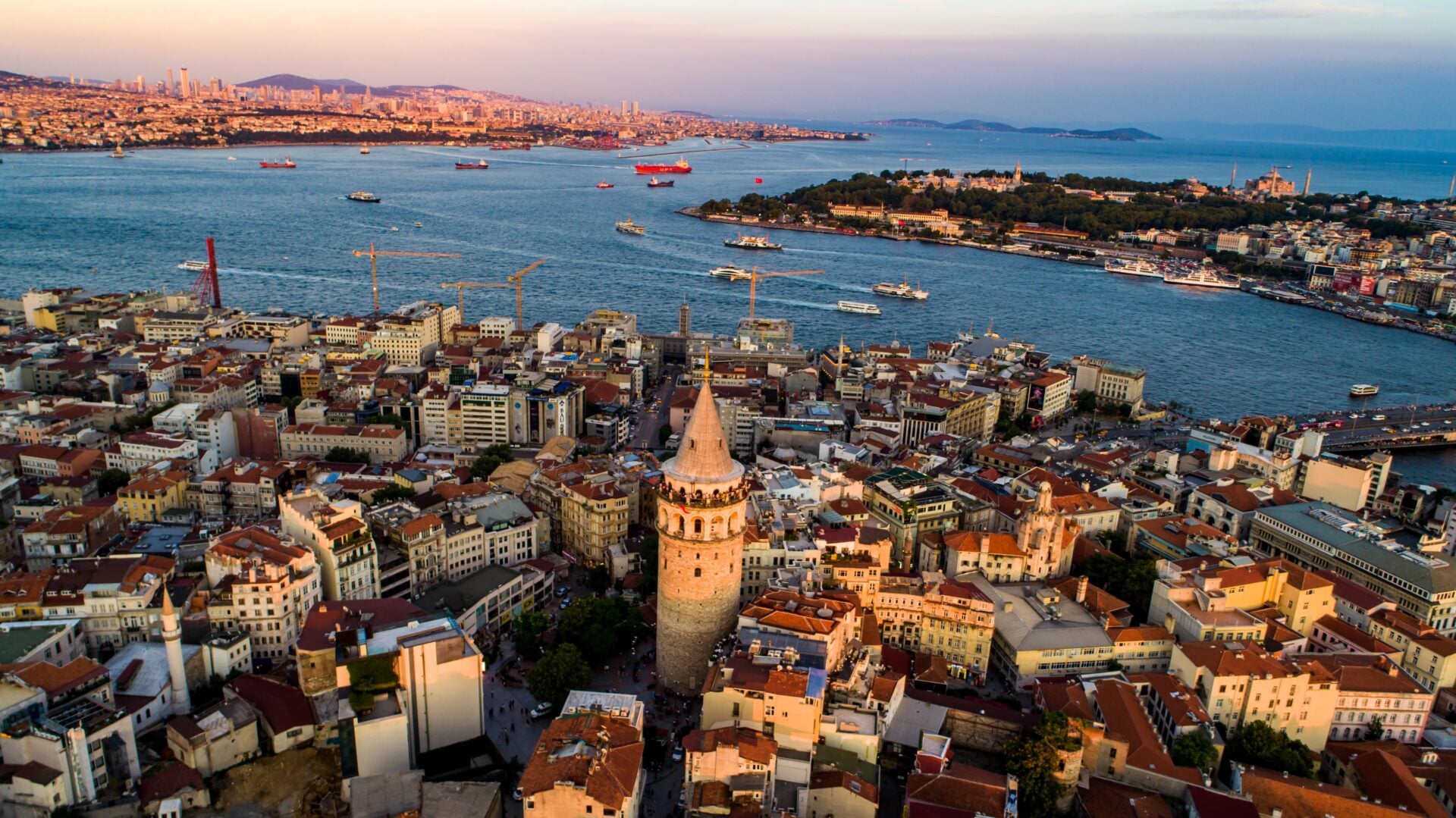 Beyoğlu rooftops sloping from Taksim down to Galata Tower and the Bosphorus