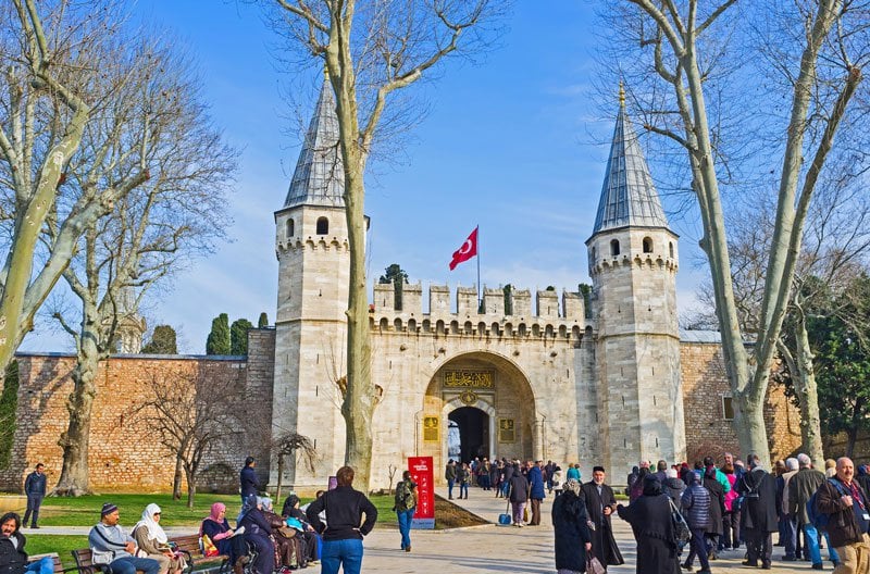 A small guided group inside a domed stone hall at Topkapı Palace
