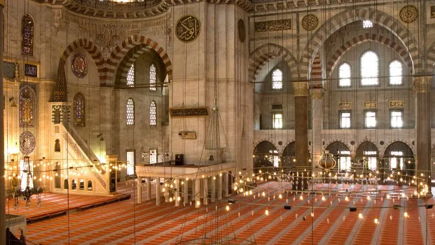 Süleymaniye's carpeted prayer hall with light pouring through the arched windows